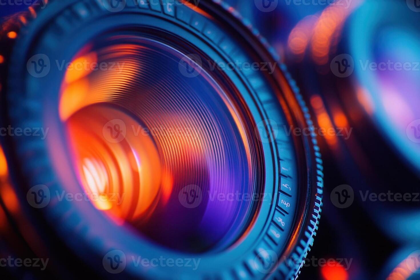 Close-up of camera lens with vibrant orange and blue lighting. photo