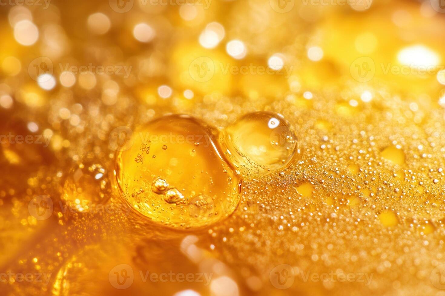 Close-up of golden, viscous liquid with bubbles and droplets. photo