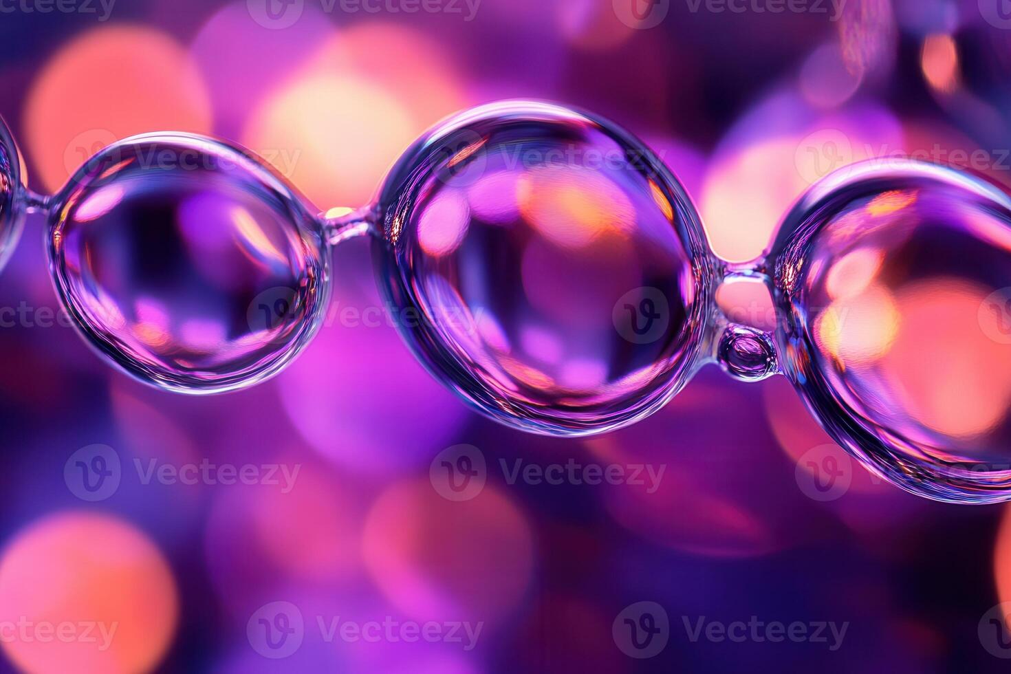 Close-up of linked translucent bubbles with purple bokeh background. photo
