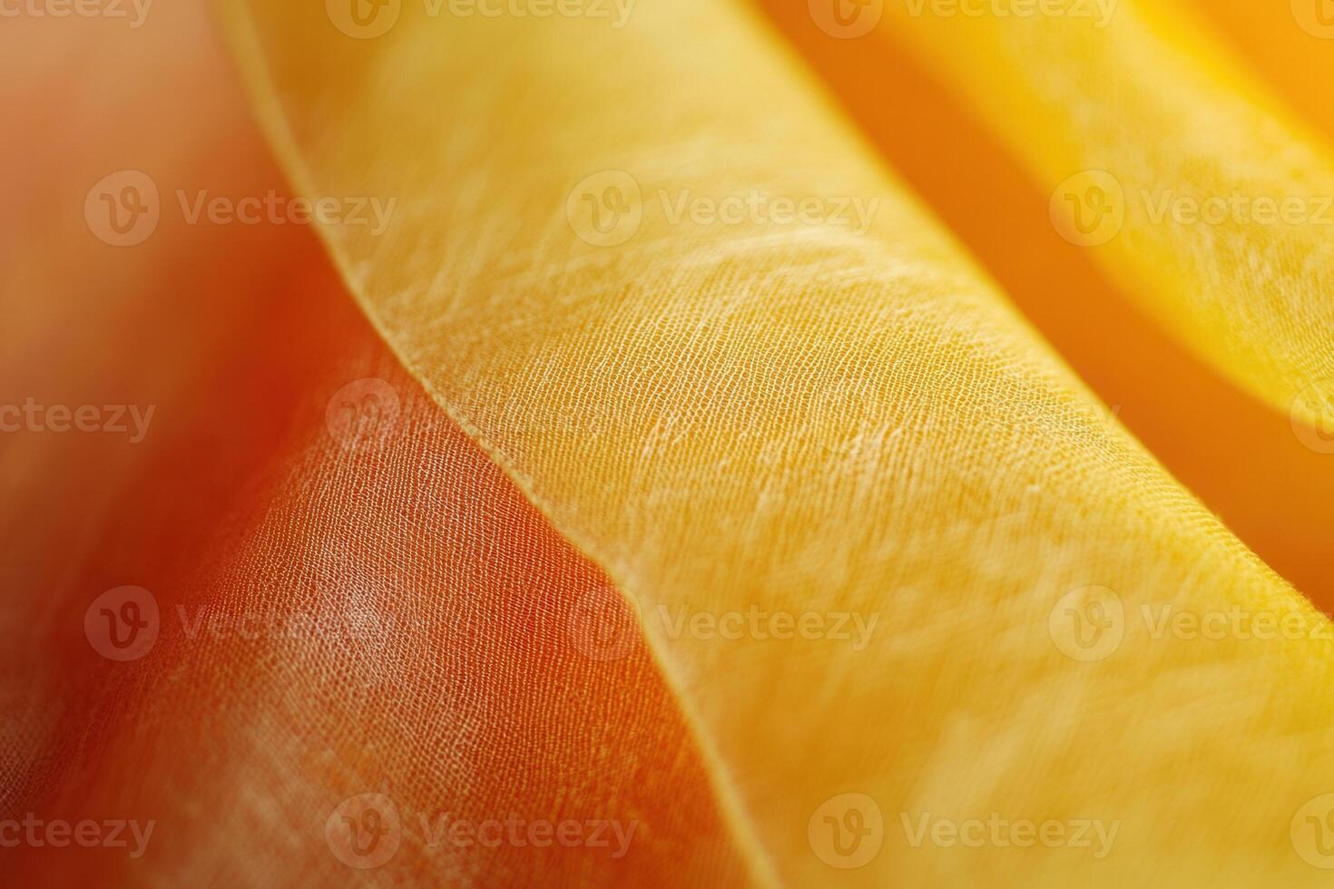 Close-up of translucent, golden-orange fabric with subtle texture and soft light. photo