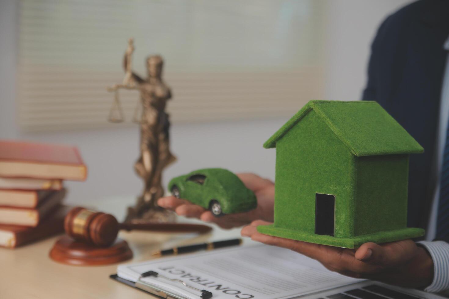 Auctioneer knocks down property sale by sample house and lawyer's gavel, judge mediates in property dispute in court car judge's gavel on wooden background Buying and selling real estate, housing photo