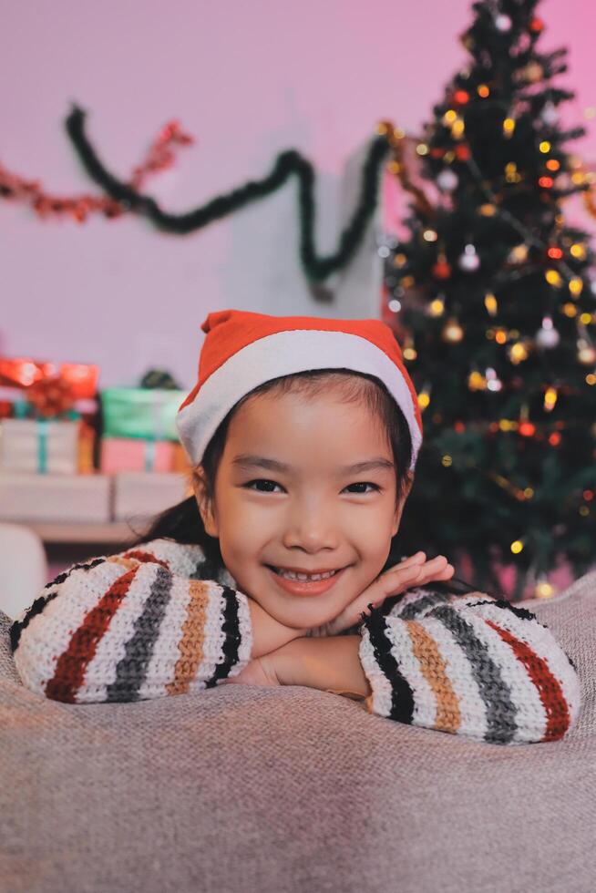 christmas, x-mas, winter, happiness concept - dreaming girl in santa helper hat photo