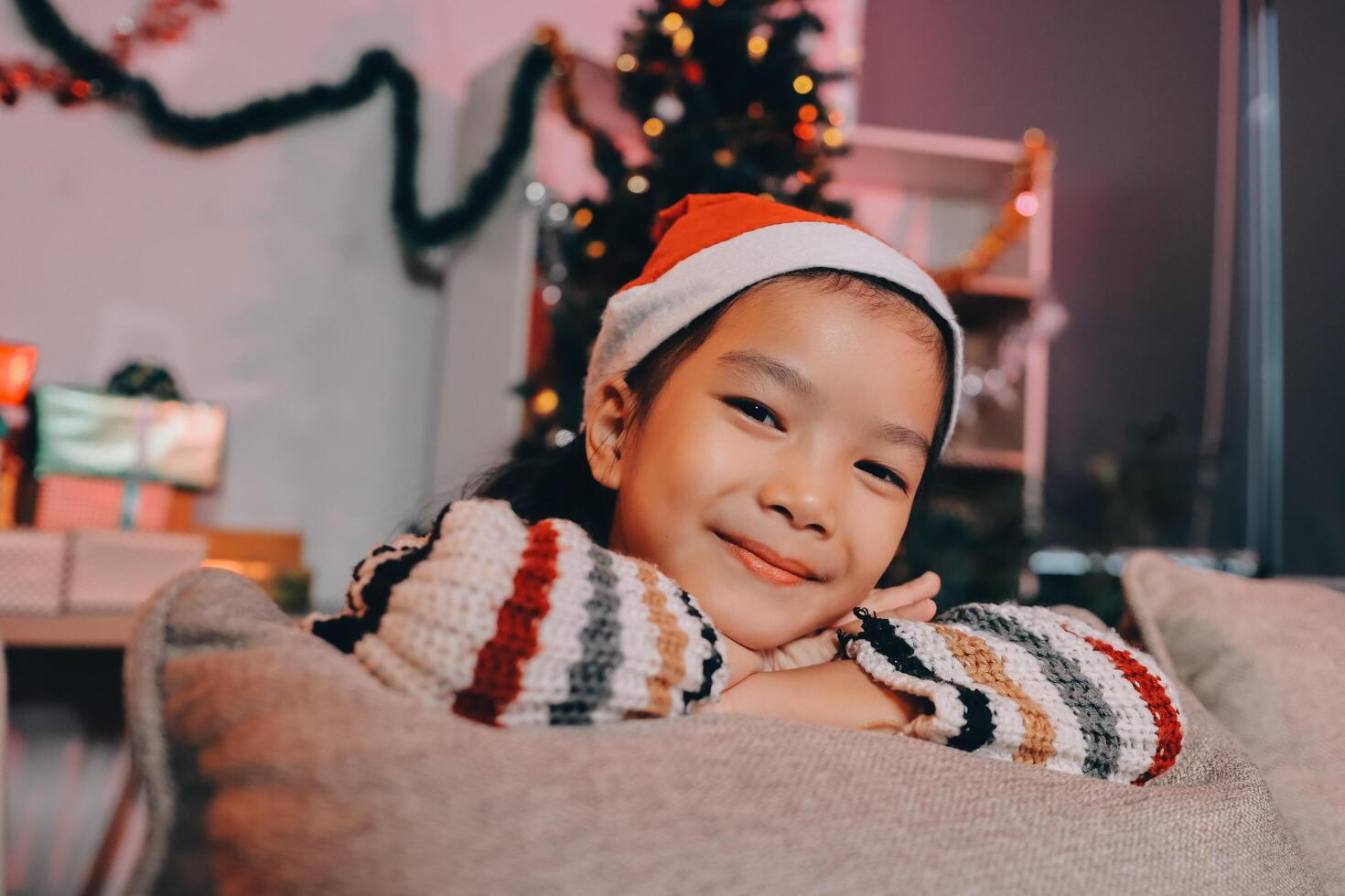 christmas, x-mas, winter, happiness concept - dreaming girl in santa helper hat photo