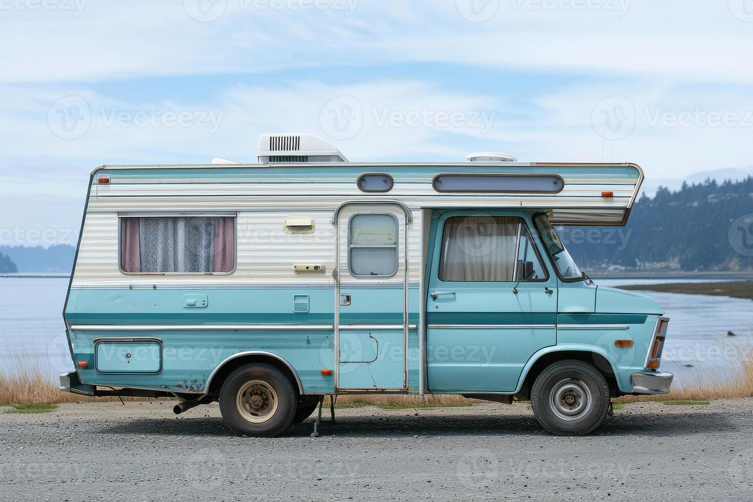 A Classic Retro Blue RV Camper Parked in a Scenic Outdoor Setting for a Nostalgic Adventure photo