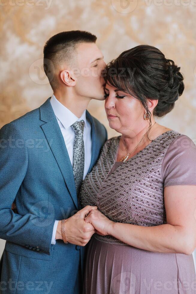 A man kisses a woman's cheek photo