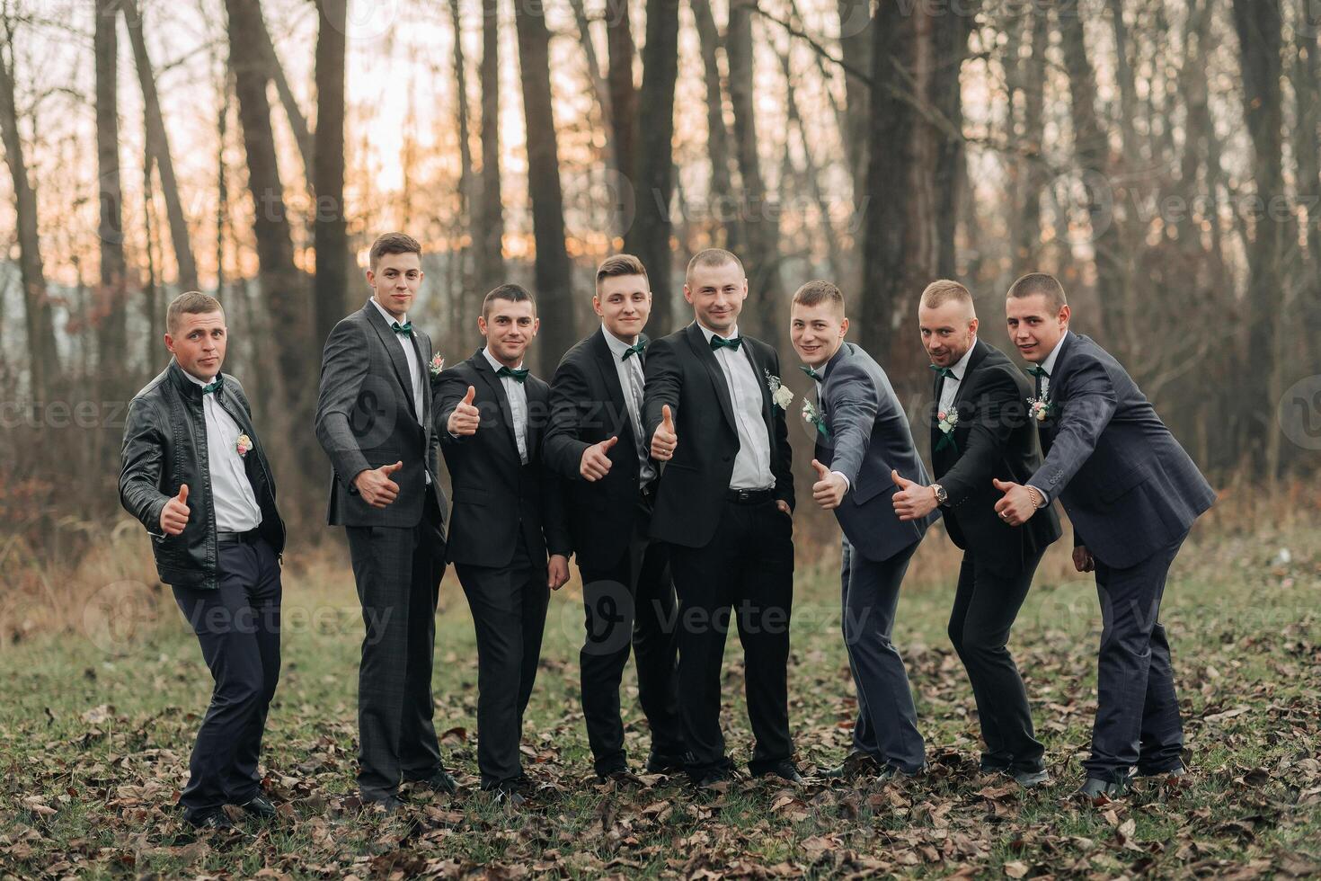 A group of men in suits are posing for a picture photo