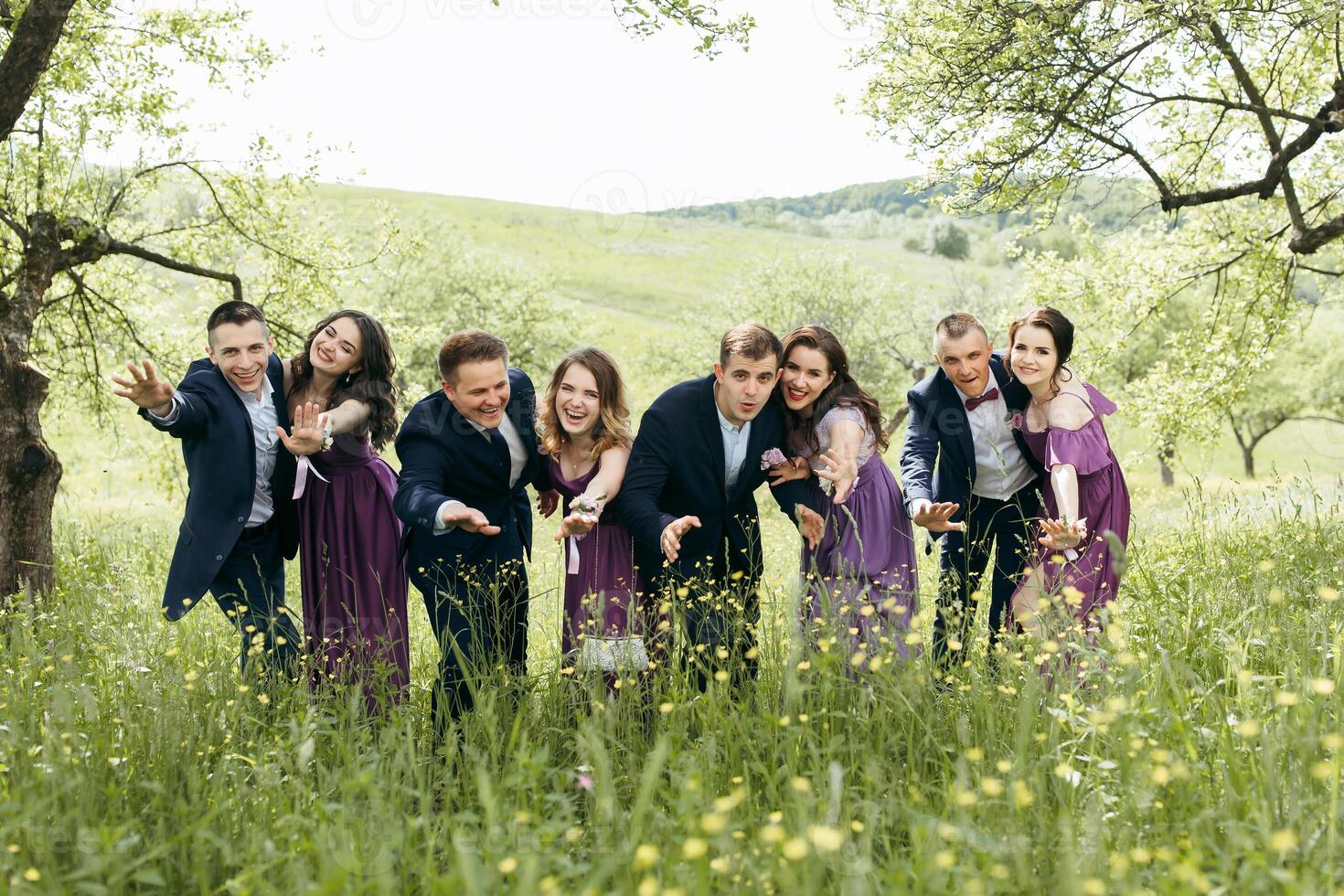A group of people posing for a photo in a field