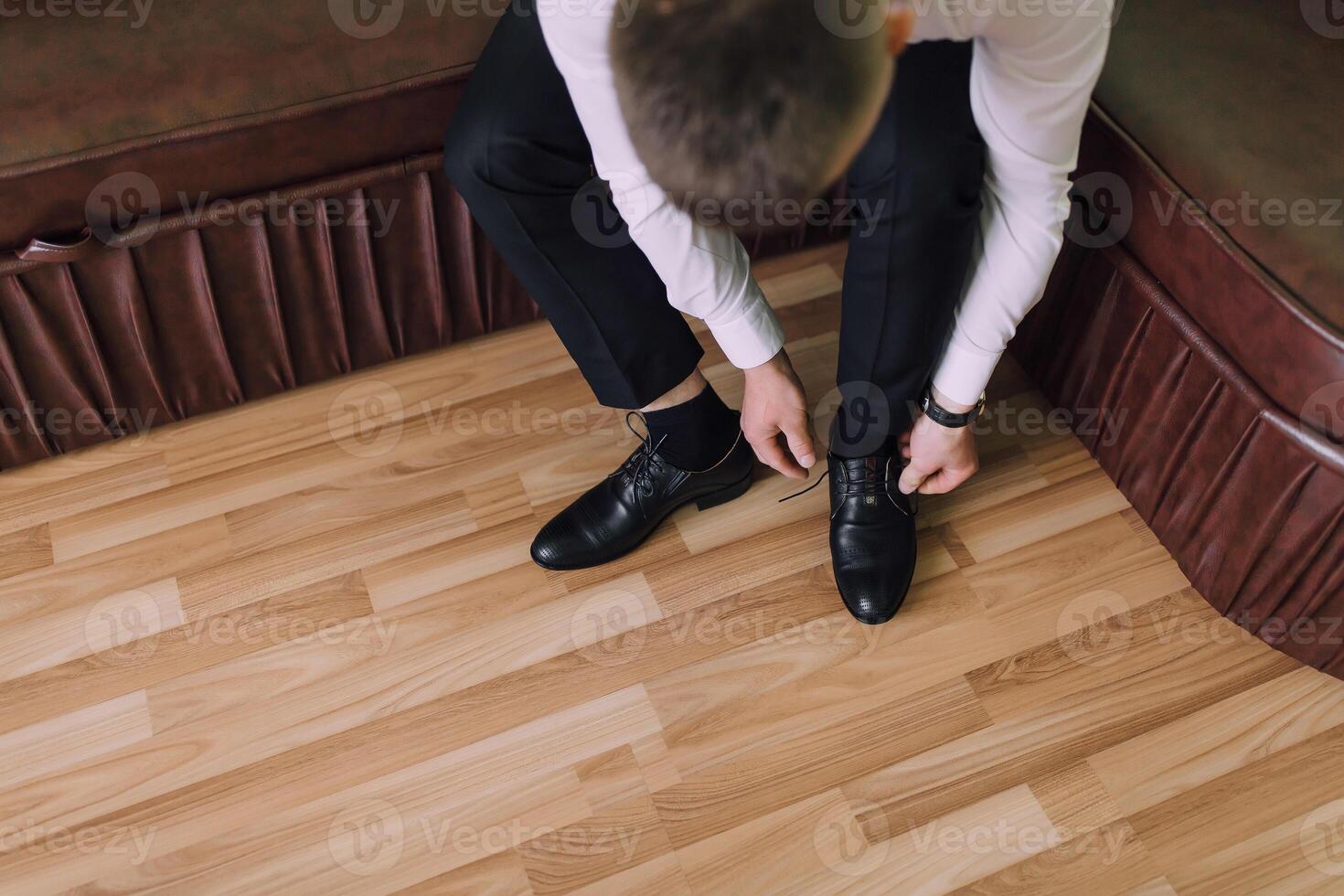 A man is getting ready to put on his shoes photo