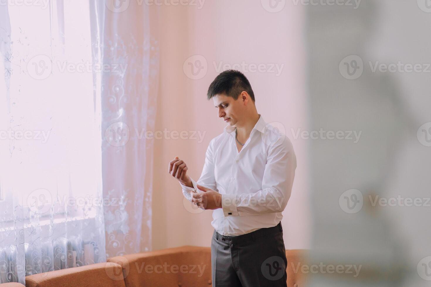 A man in a white shirt is getting ready to leave the house photo
