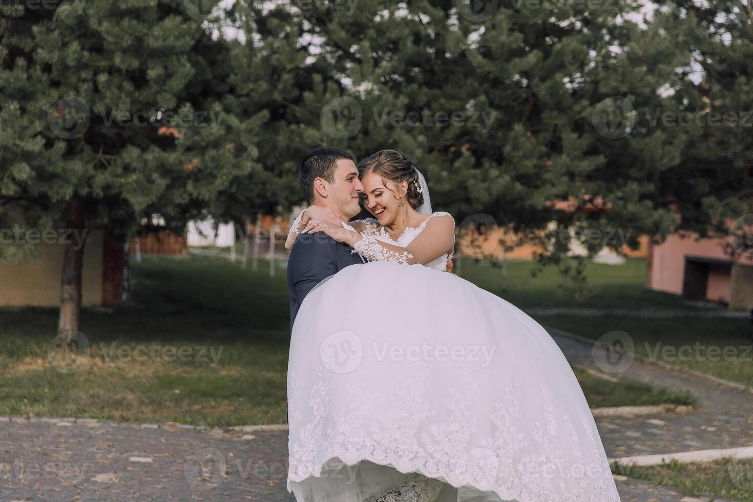 A bride and groom are standing in a field photo