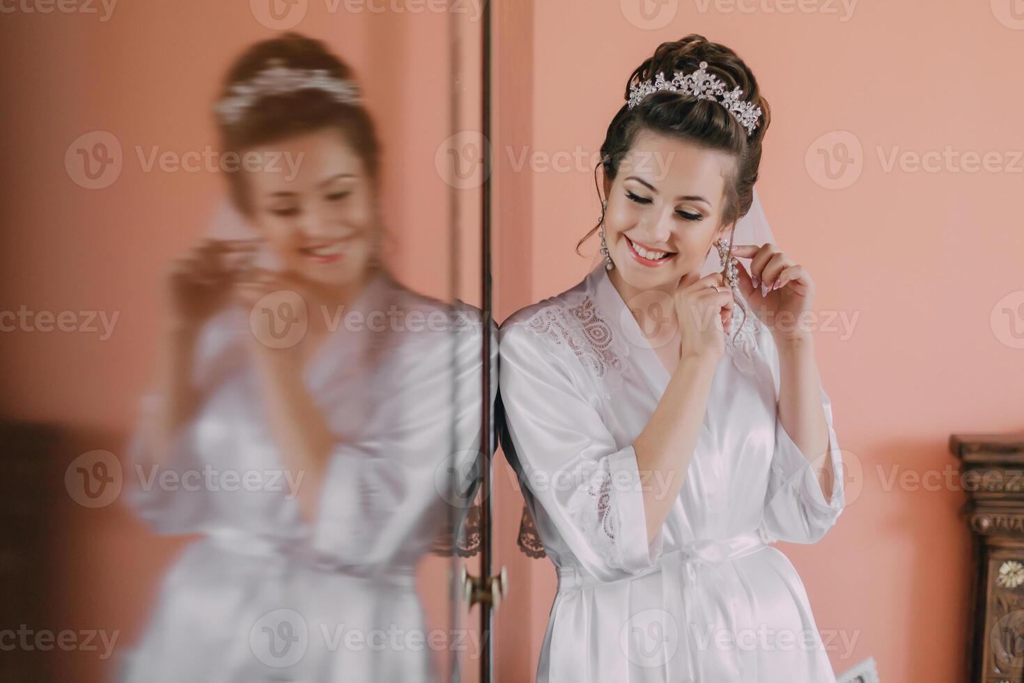 A woman in a white robe is getting ready for a wedding photo