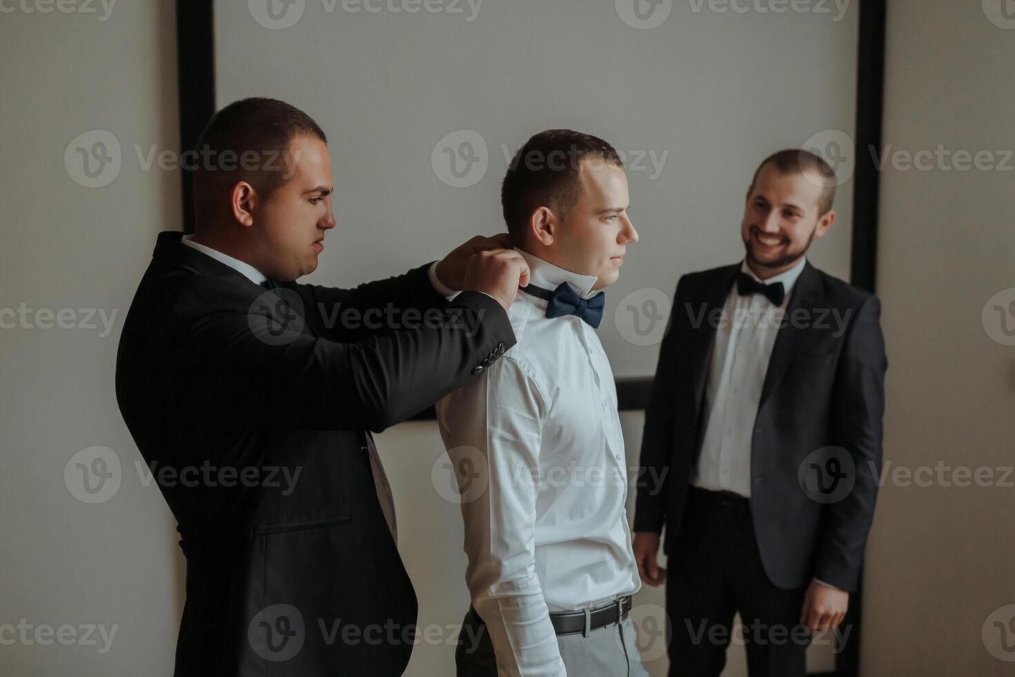 Three men are dressed in suits and ties photo