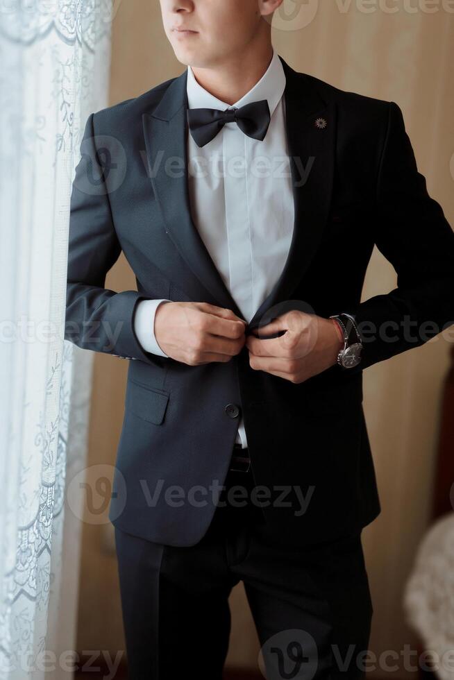 A man in a suit is getting ready to go out photo