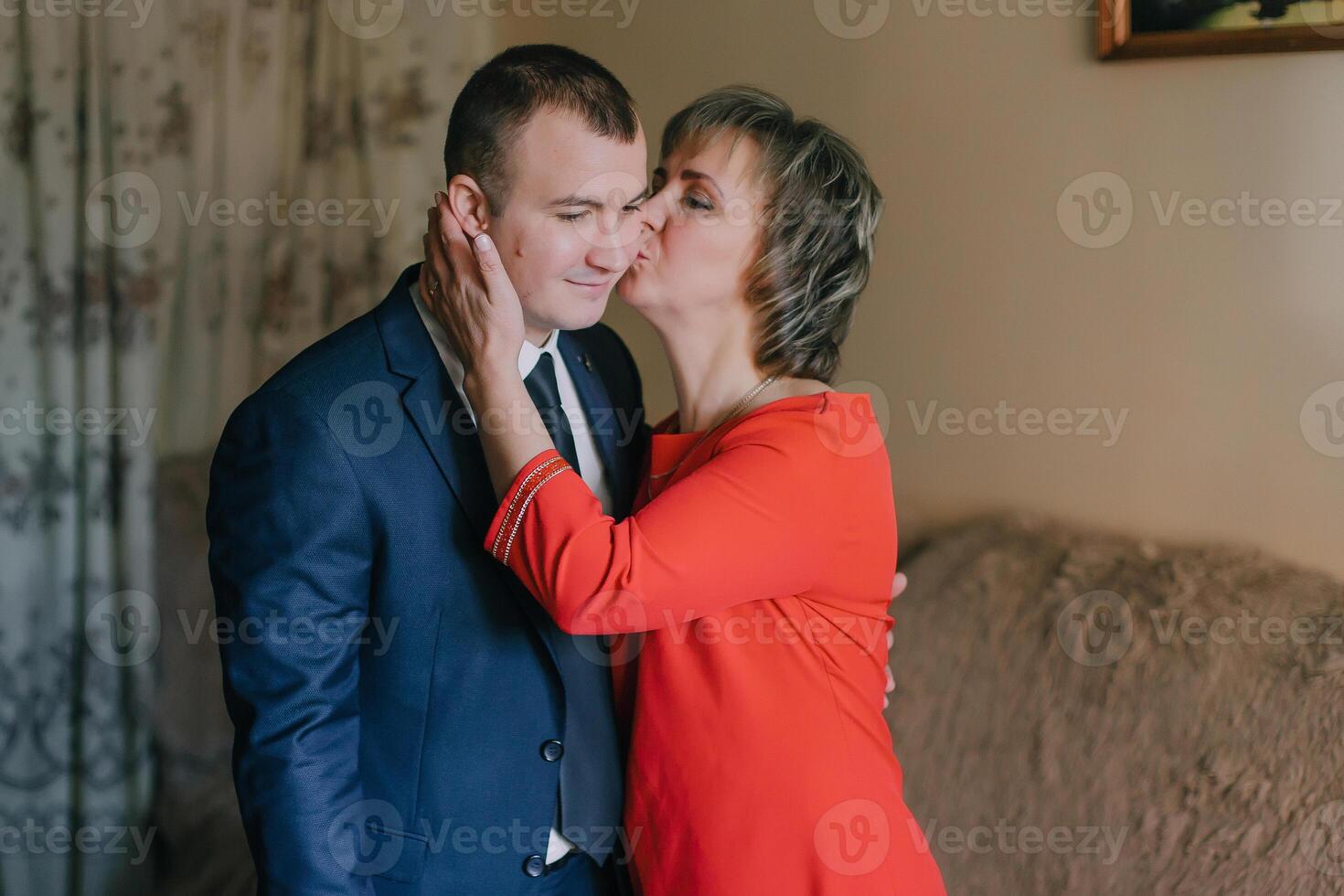 A man kisses a woman's neck photo