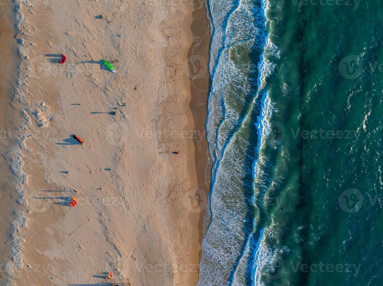 Aerial View of Tarifa Beach with Colorful Kites and Turquoise Ocean photo