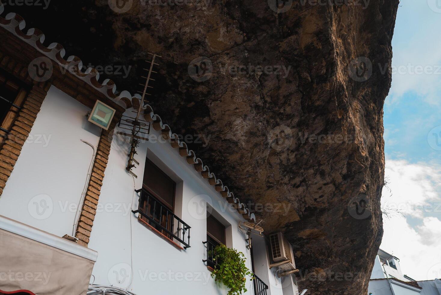 Whitewashed Buildings Under Rock Formations in Setenil De Las Bodegas photo