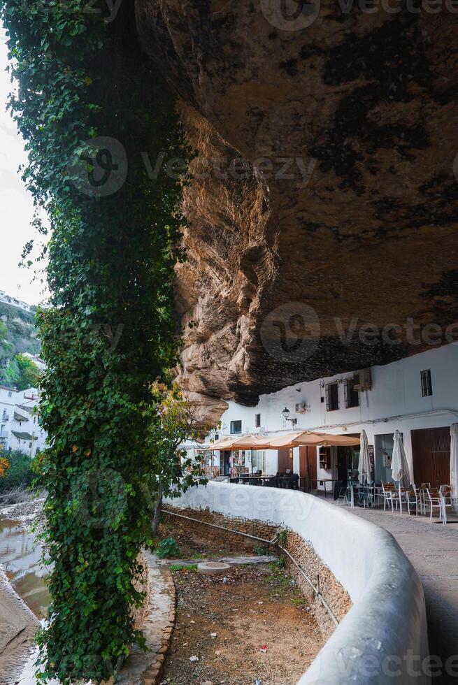 Whitewashed Buildings Under Rock Formations in Setenil De Las Bodegas photo