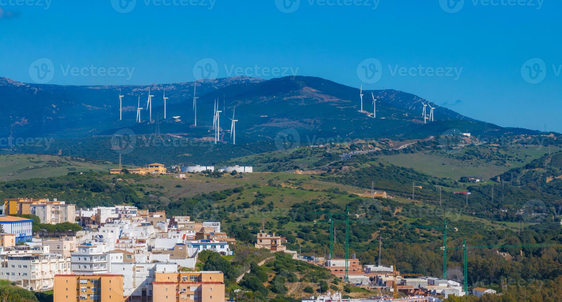 Aerial View of Tarifa Town with Wind Turbines and Rolling Hills photo