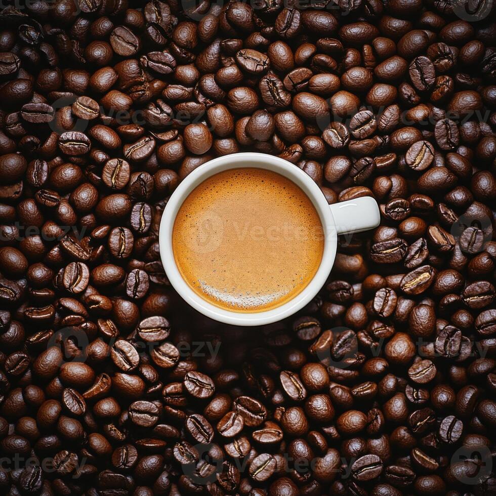 A steaming cup of coffee placed on a bed of roasted coffee beans photo