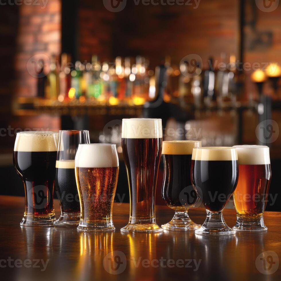 Various types of beer in different shaped glasses placed on a bar counter, showcasing a range of beers from light golden to deep amber and dark brown photo
