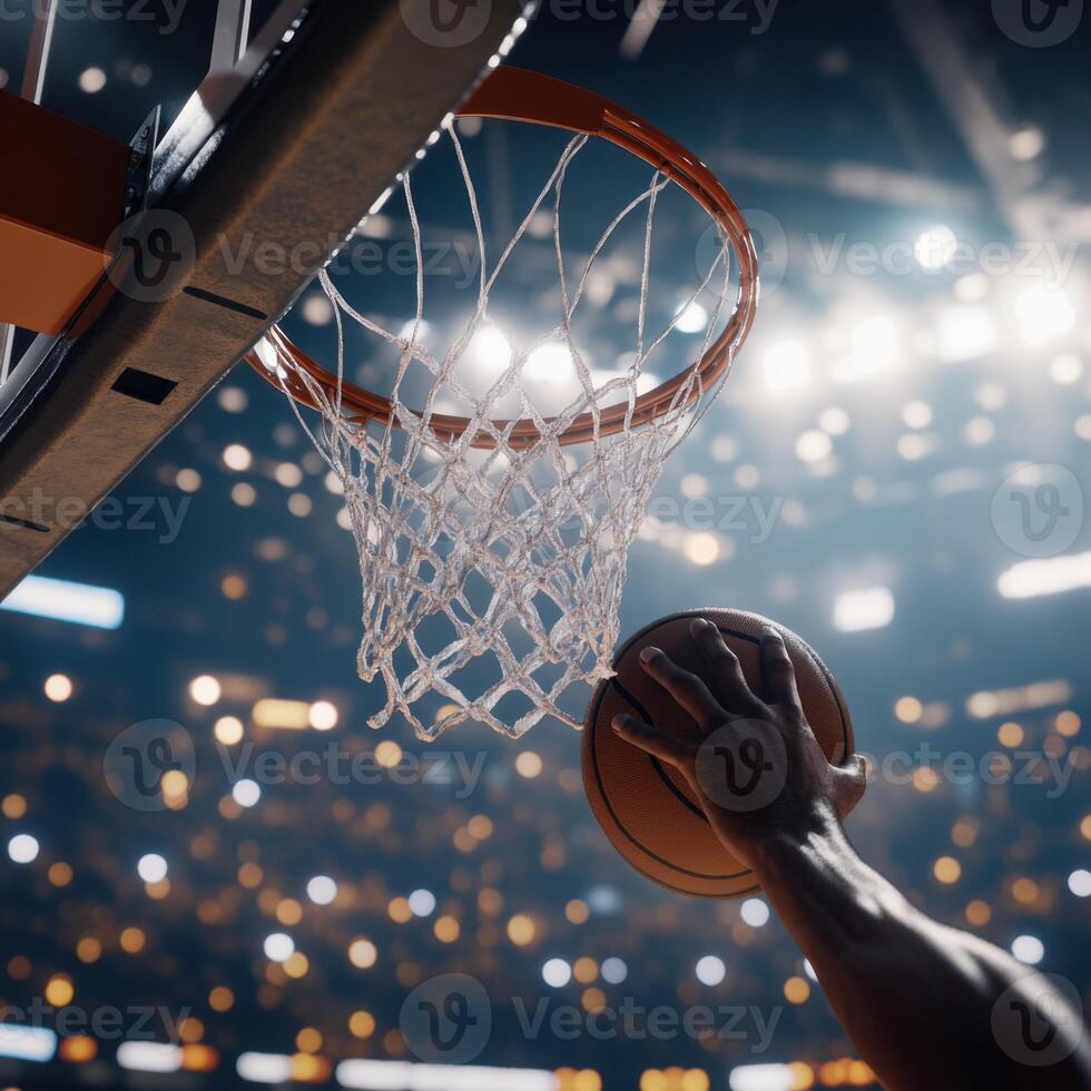 action shot of a basketball being dunked into the hoop by a player's hand, with the ball just about to pass through the net. photo