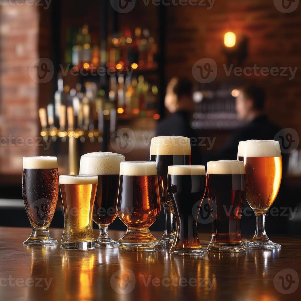 Various types of beer in different shaped glasses placed on a bar counter photo