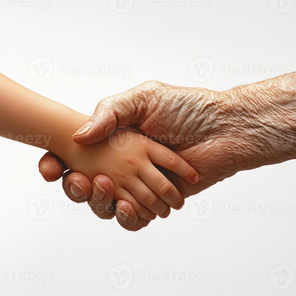 A poignant image of a child and an elderly person shaking hands, symbolizing the connection between generations, set against a pure white background photo