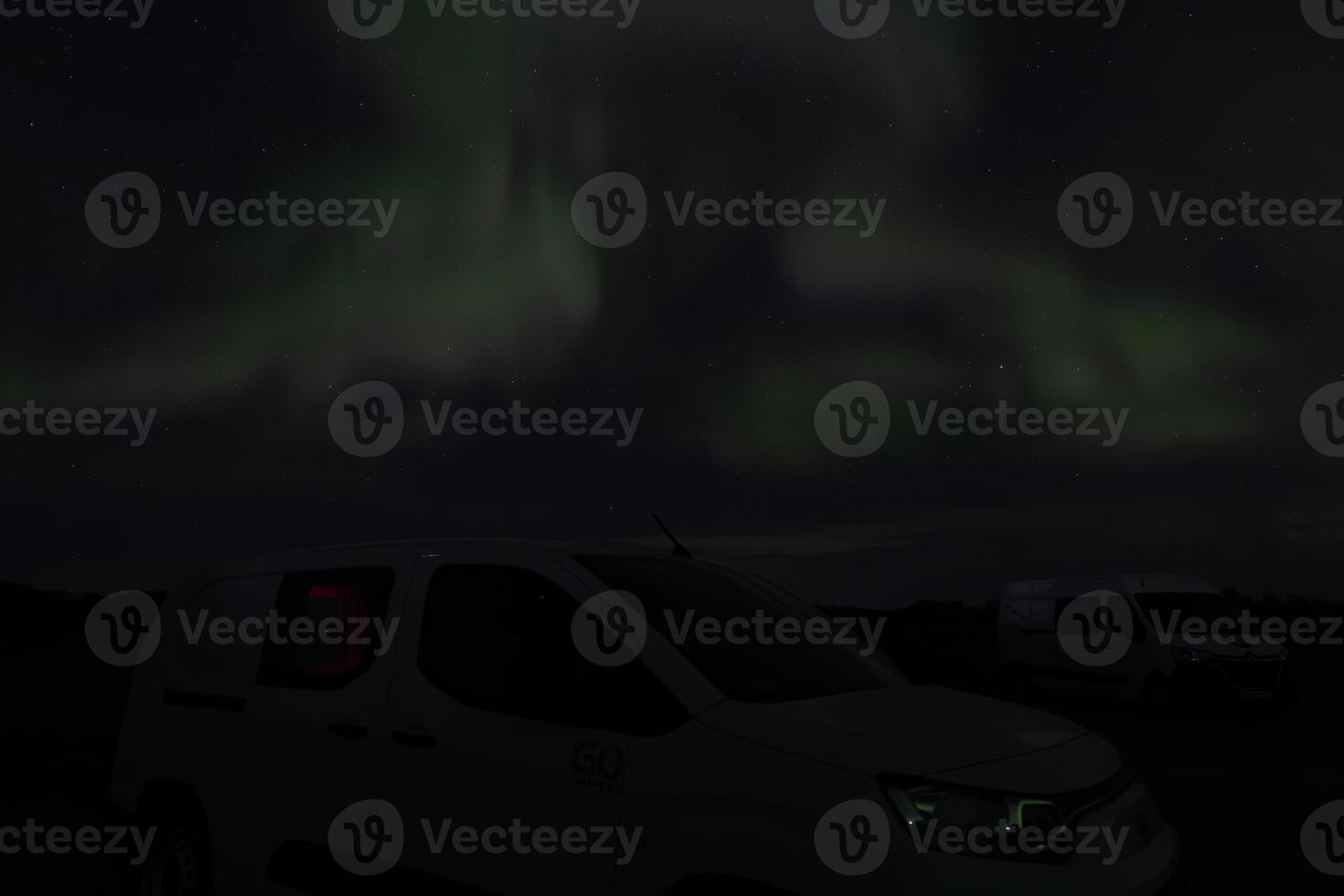 Aurora borealis over in the dark night. The dark sky and filled with stars photo