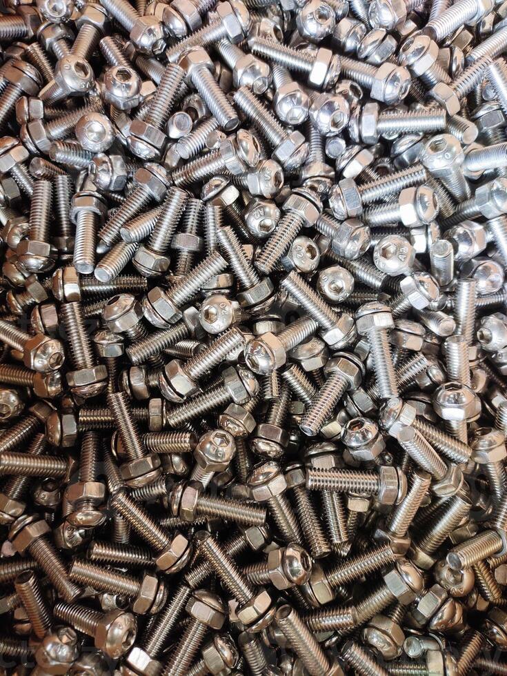 A close-up of stainless steel hex bolts and nuts in a shiny pile, showcasing durability, corrosion resistance, threading, and uniform design. Perfect for industrial, hardware, or engineering themes. photo