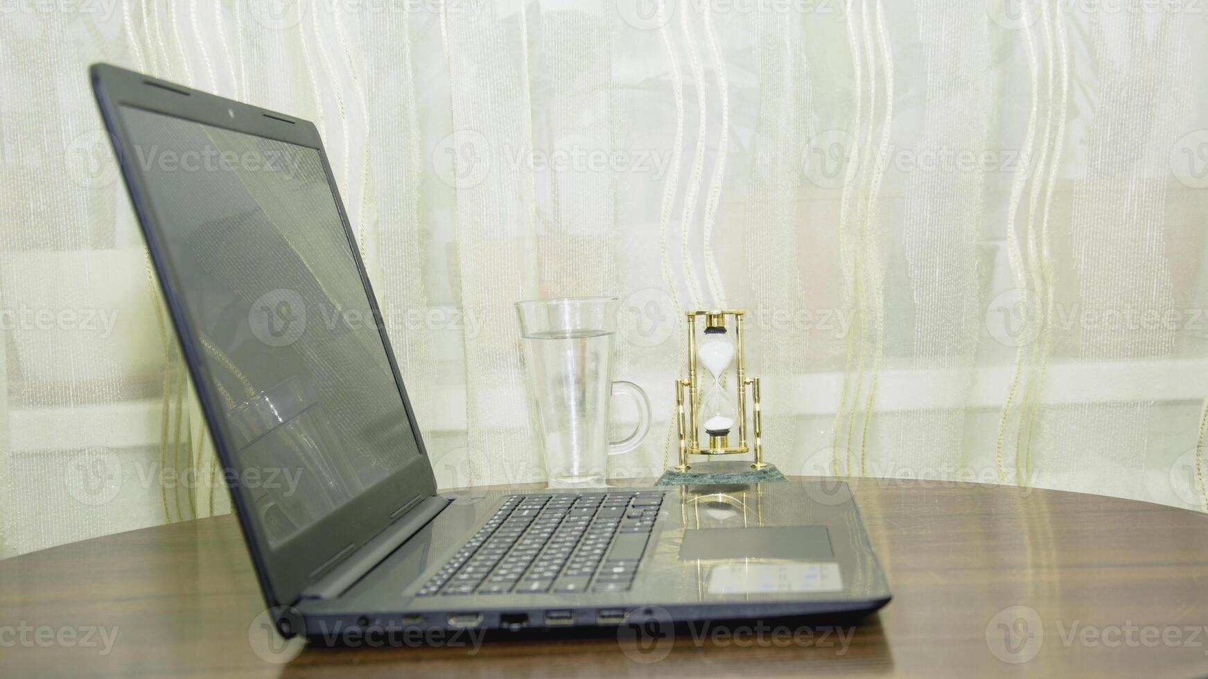 A laptop computer sitting on a table photo