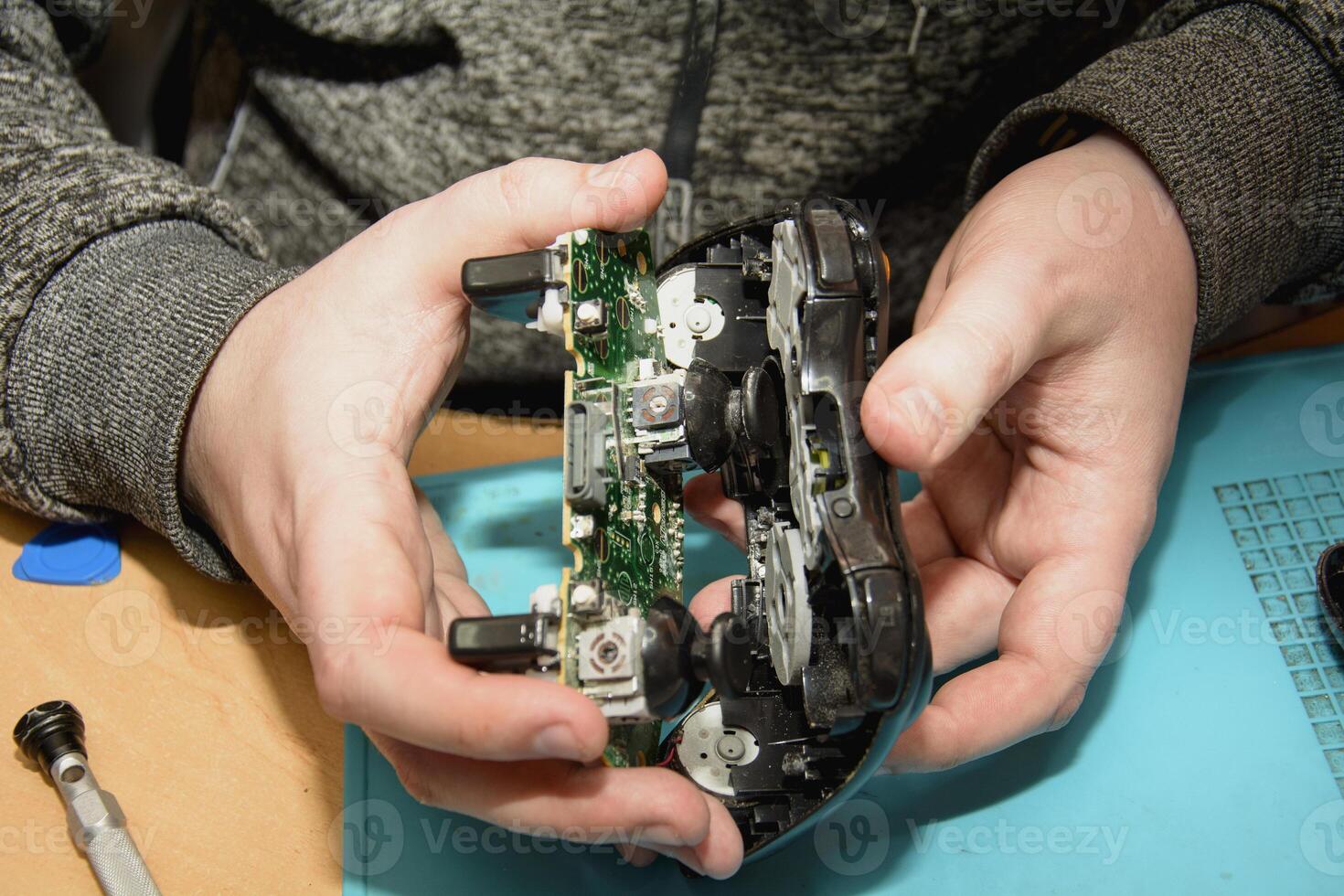 A person is holding a game controller photo