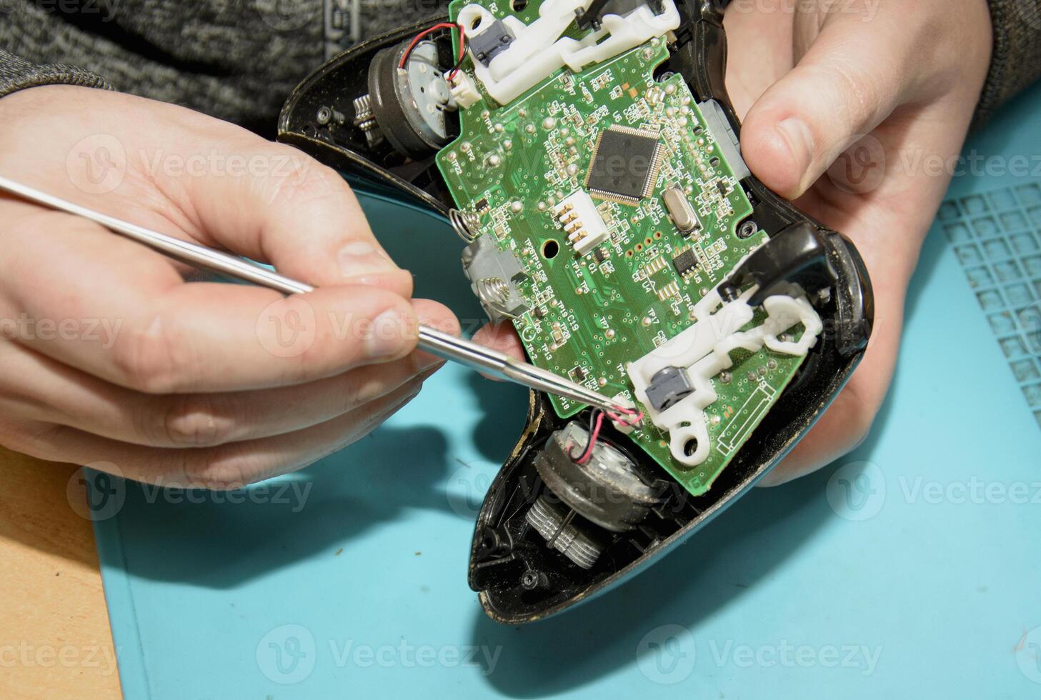 A person is working on a game controller photo