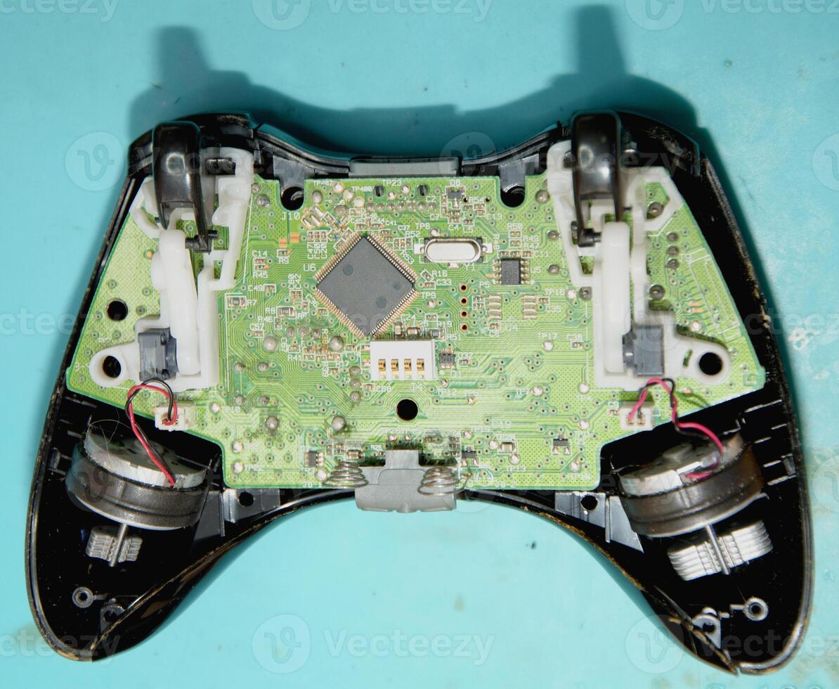 A game controller with wires and a circuit board photo