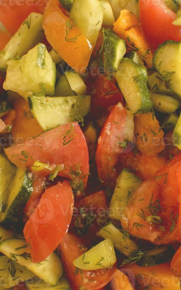 A plate of vegetables with tomatoes and cucumbers photo