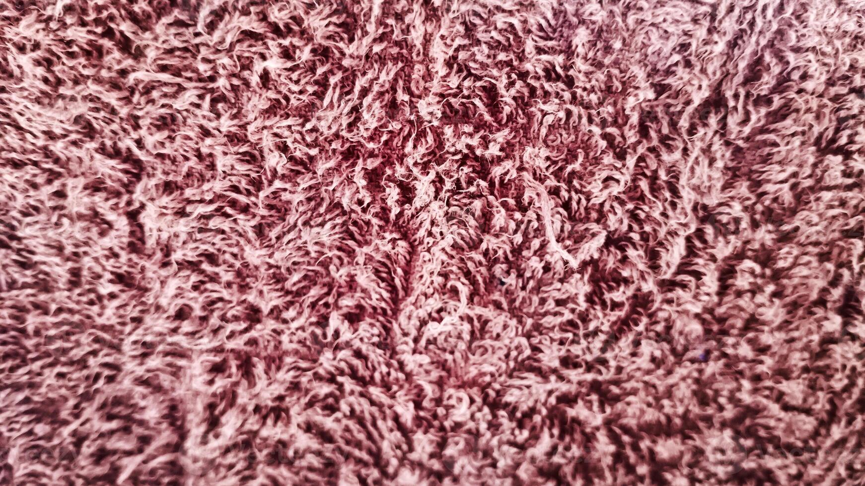 A close-up of plush, soft fabric with rich texture and vibrant color. Ideal for themes of comfort, luxury, and cozy home decor. photo
