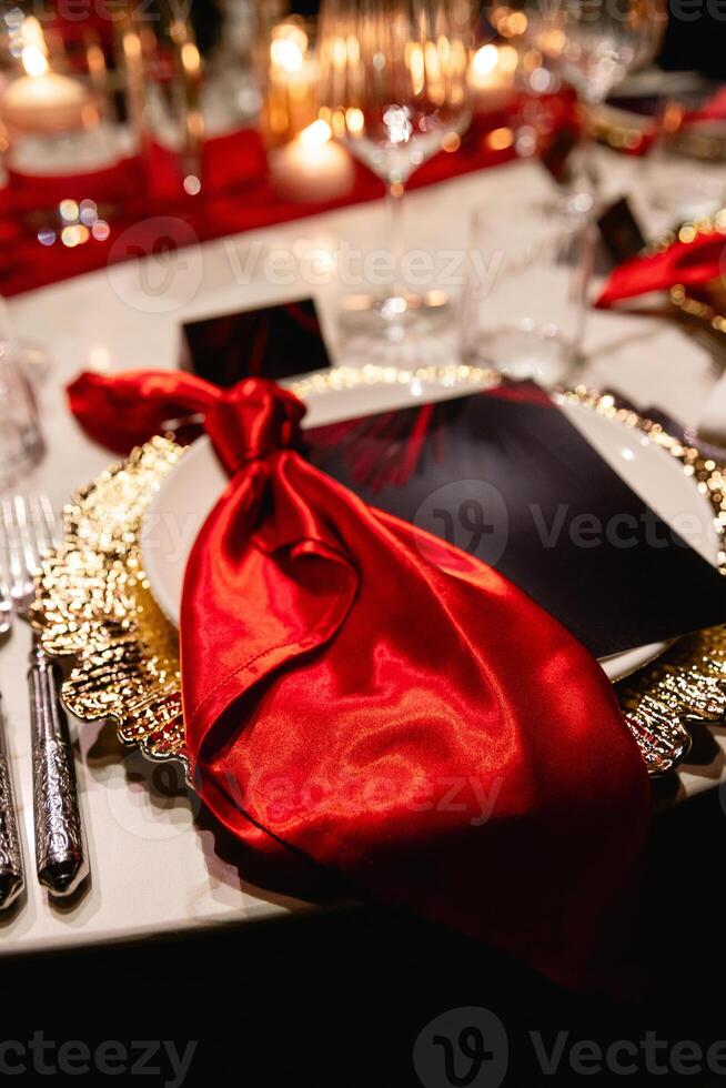 A red napkin on a luxurious wedding table for guests creates an elegant ambiance photo