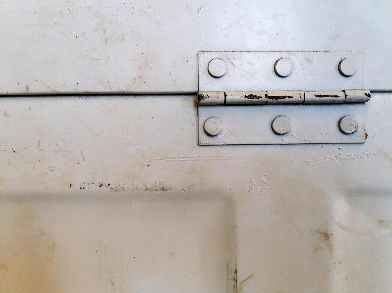 Close up old steel white door or window hinge with copy space. Vintage and Retro object concept. photo
