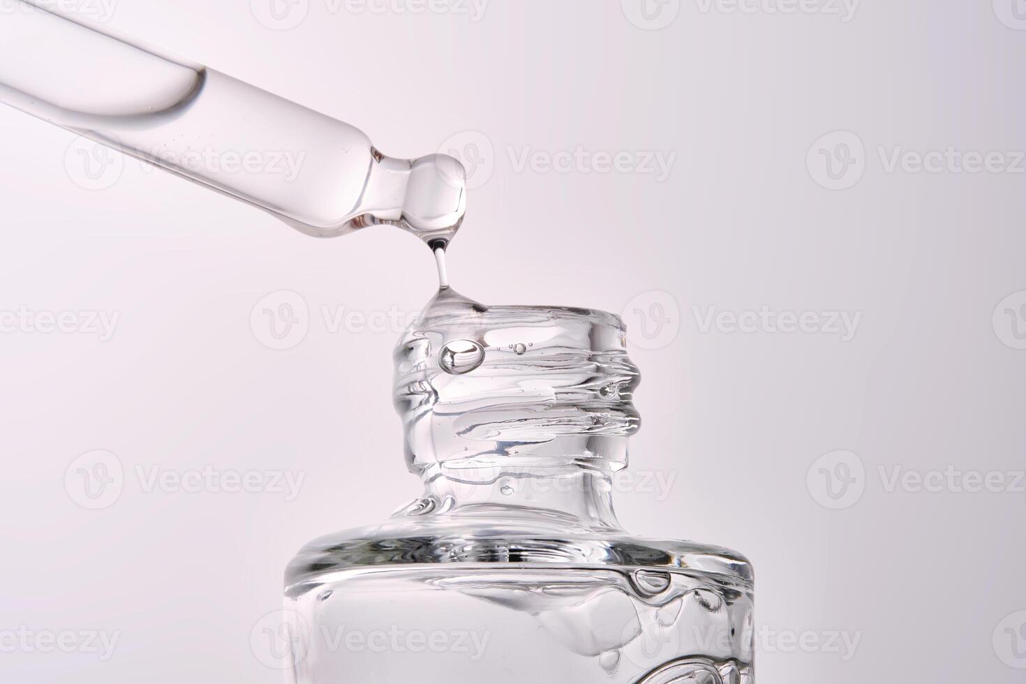 Close-up of a cosmetic bottle with a pipette showing the texture of the serum. photo