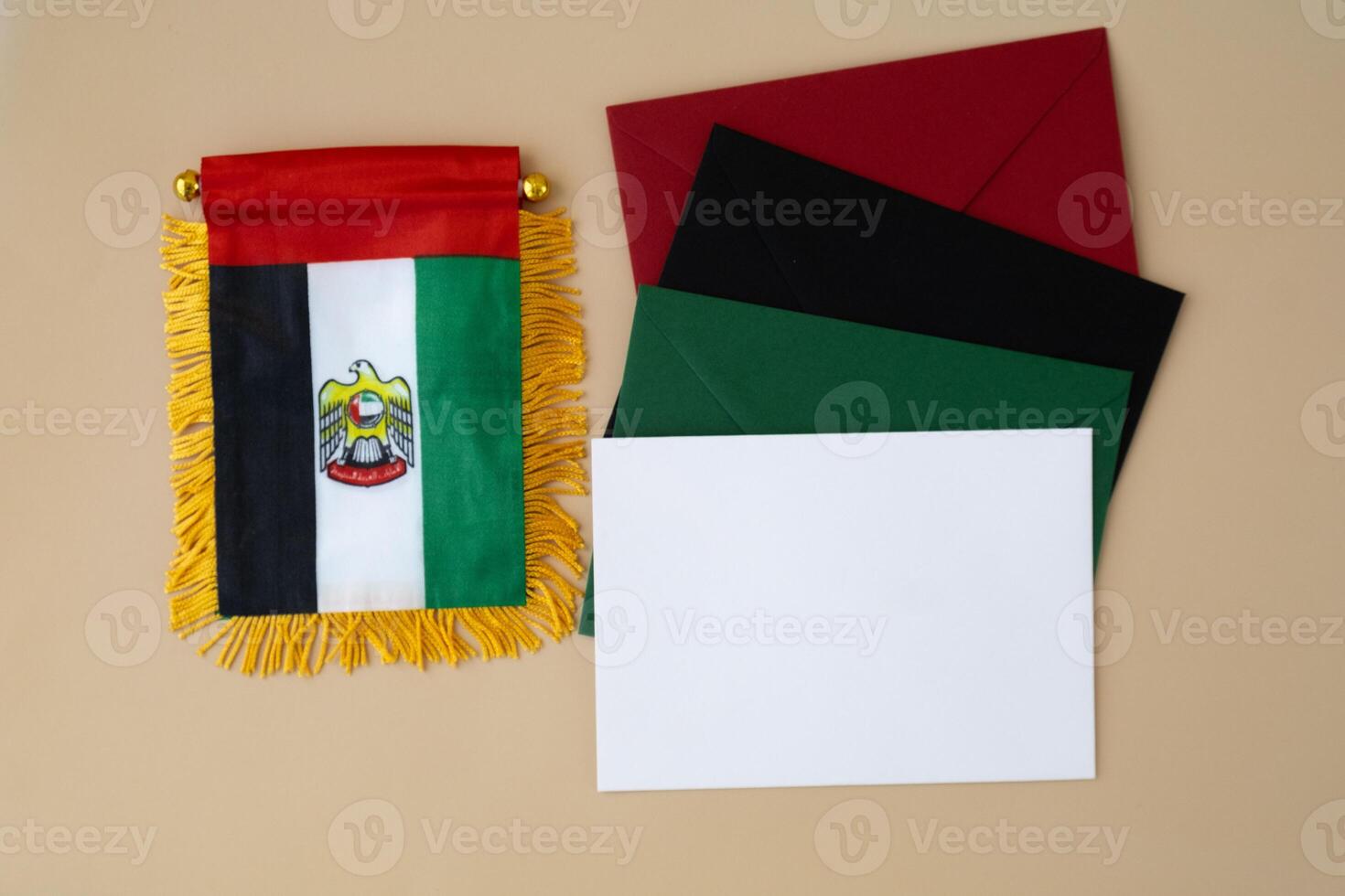 Small flag of UAE on beige background with colorful envelopes. Copy space. Mock up advertisement template. Tourism travel voucher with United Arab Emirates national symbol. Visit Dubai concept photo