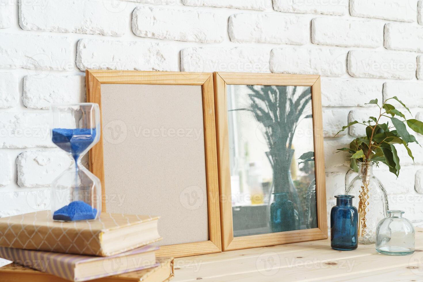Photo frames on a brick wall background on the table with wheat ears in vase