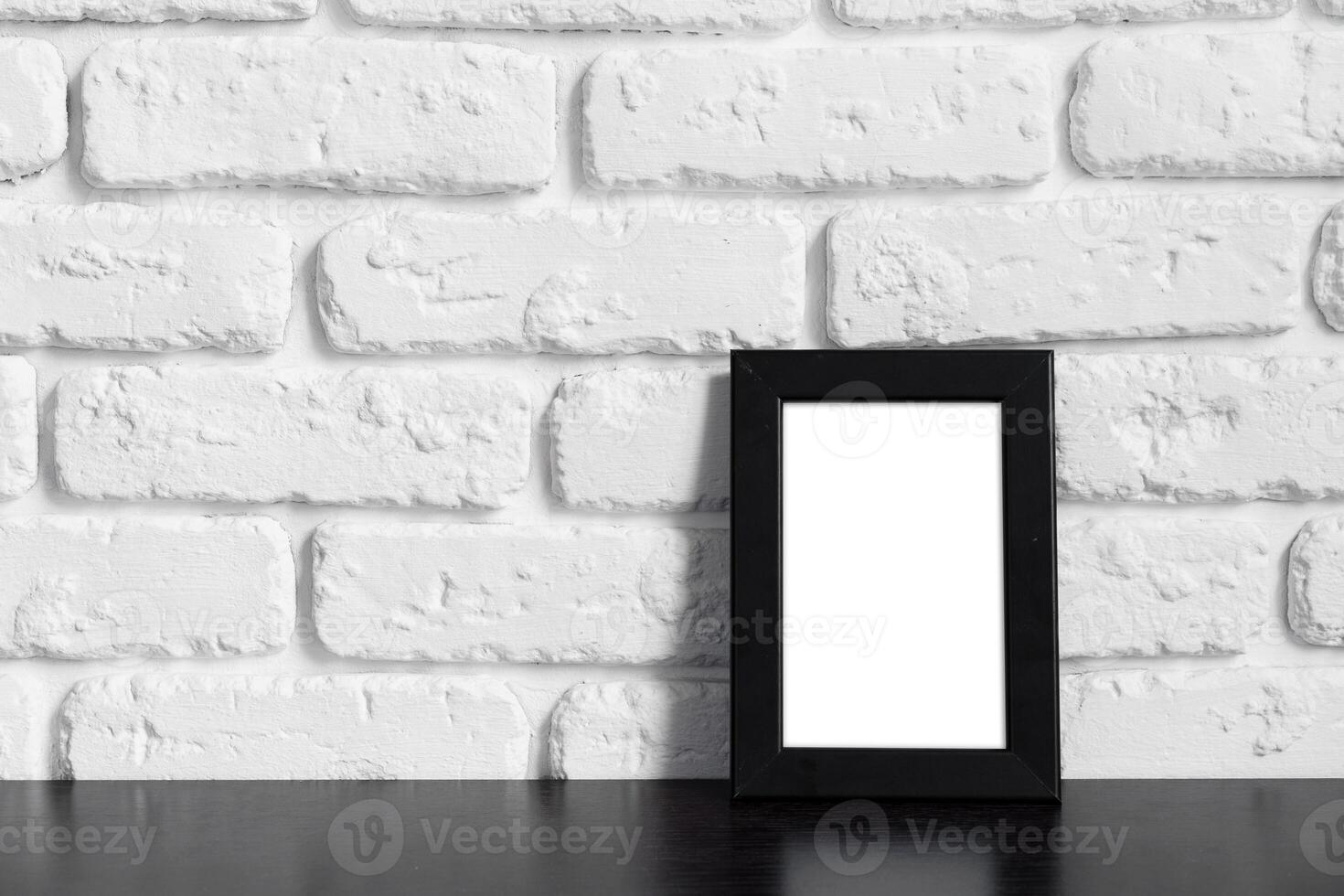 Photo frame with copy space against white brick wall