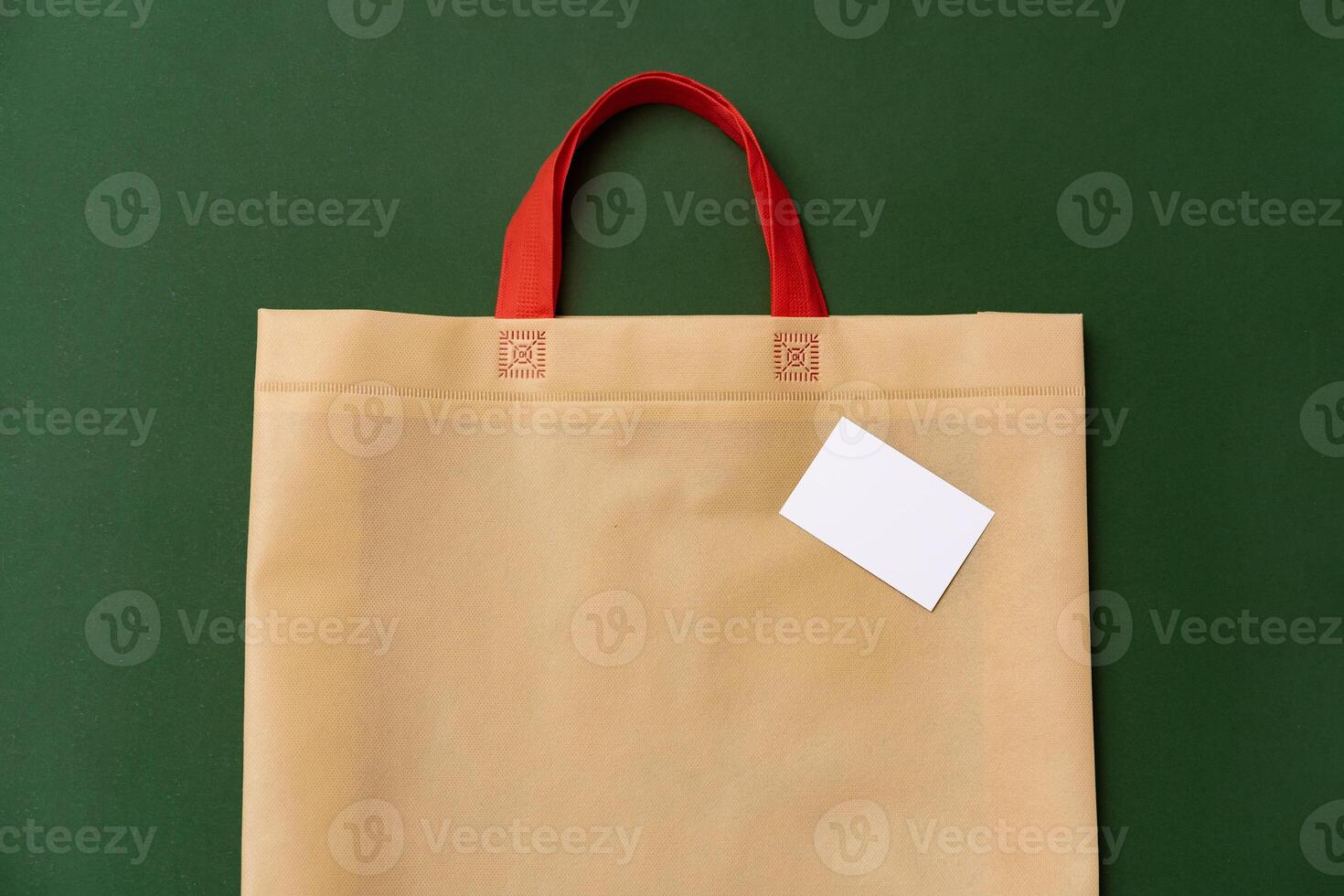 Textile shopping bag on green background flat lay photo