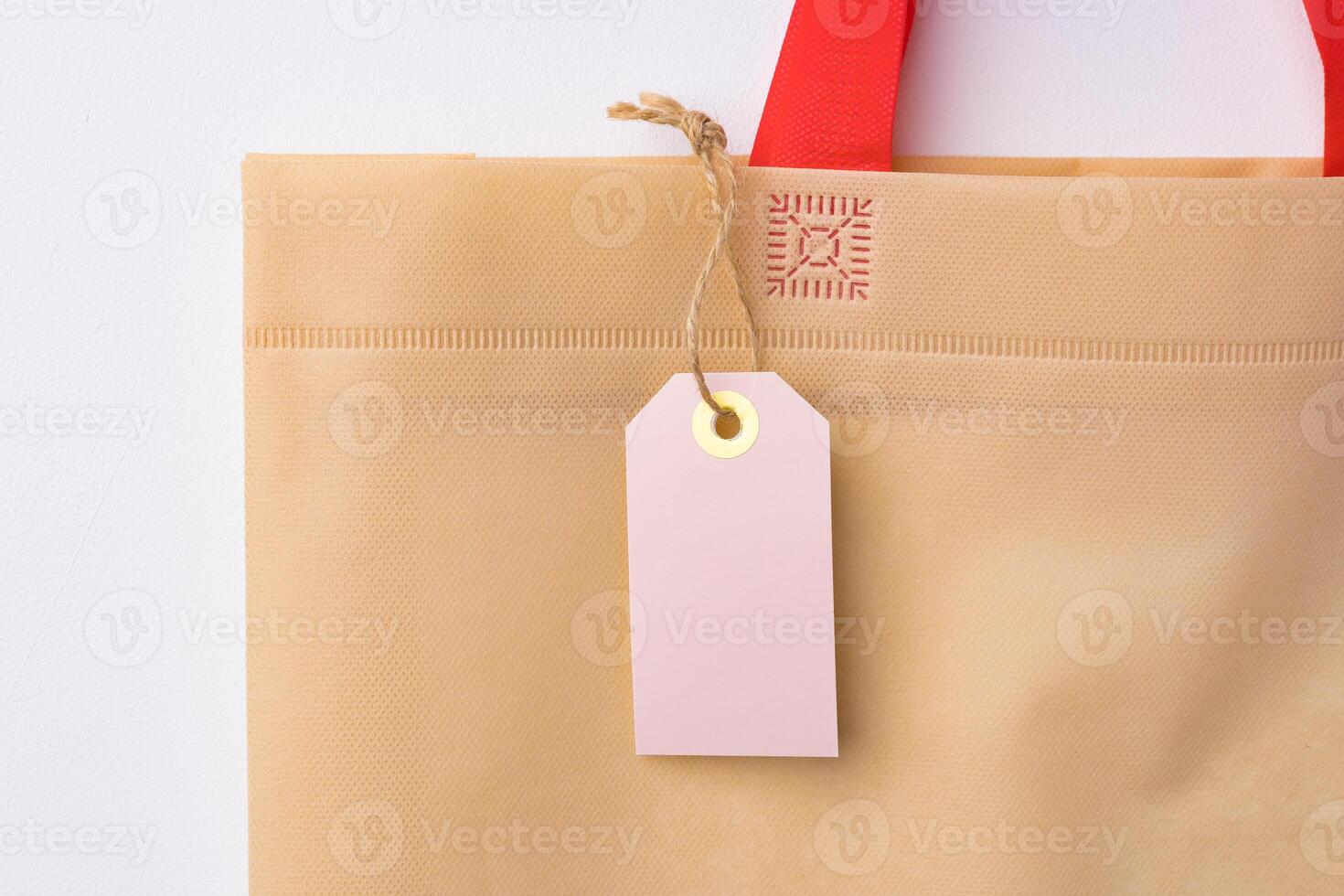 Blank paper tag with shopper paperbag on white background photo