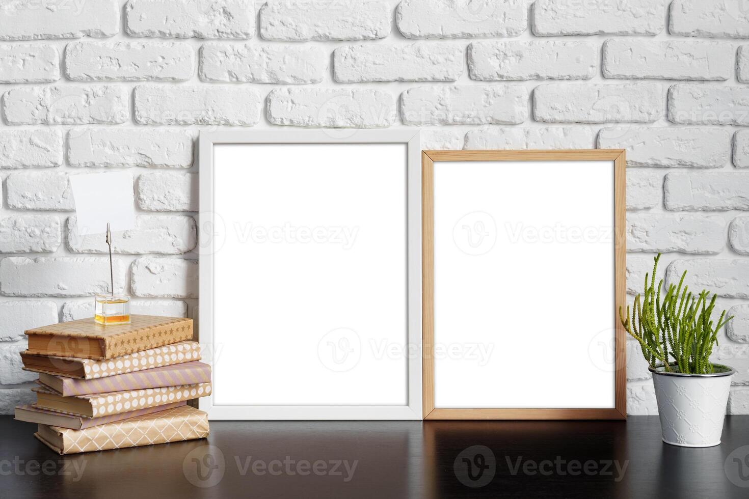 Books with picture frame on wooden table photo