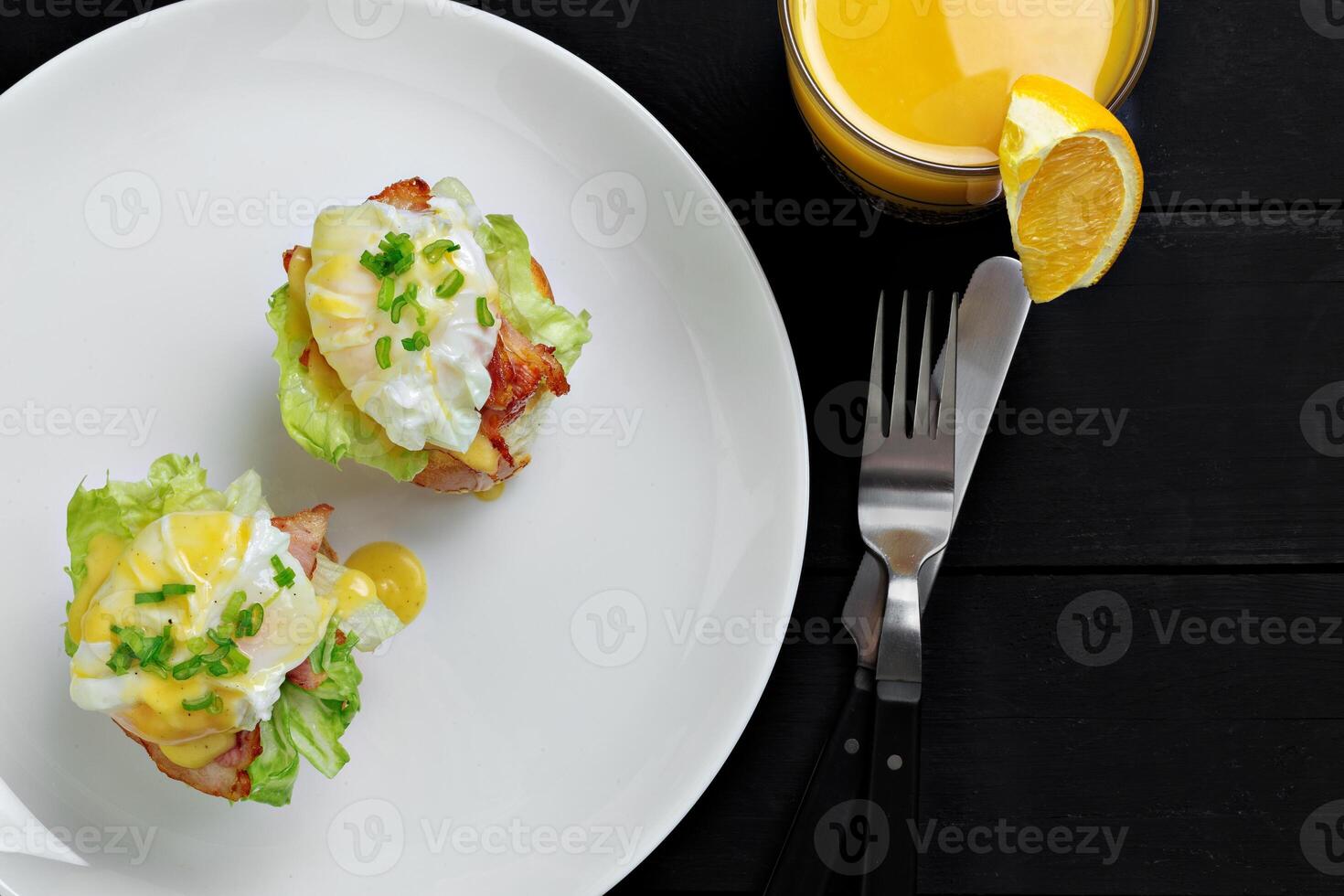 Top view of toasted buns with bacon, lettuce and poached egg photo