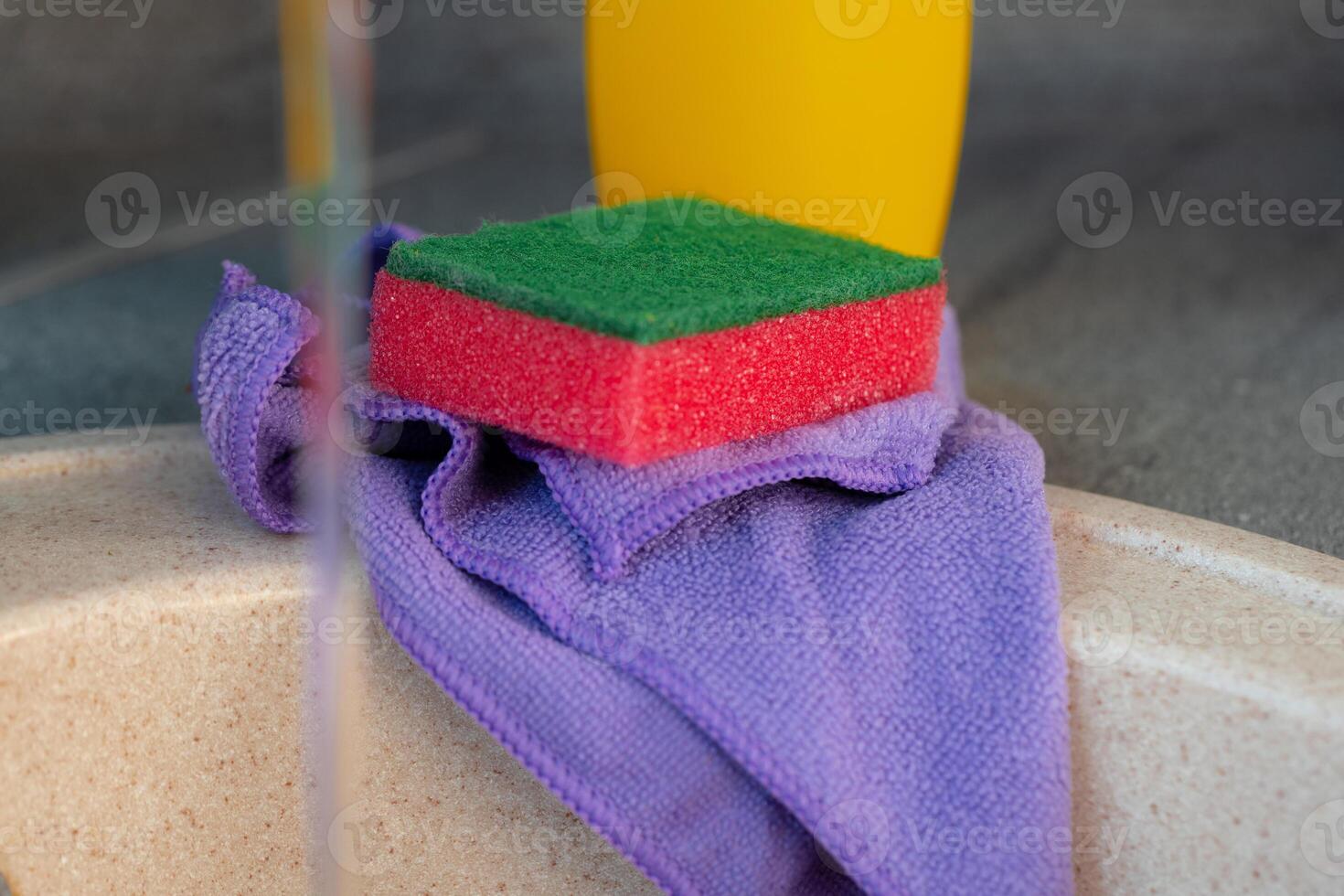 Cleaning sponge and rag on kitchen counter photo