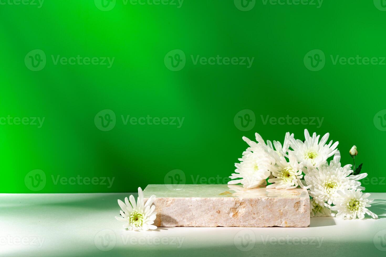 Mock up stone podium against green background photo