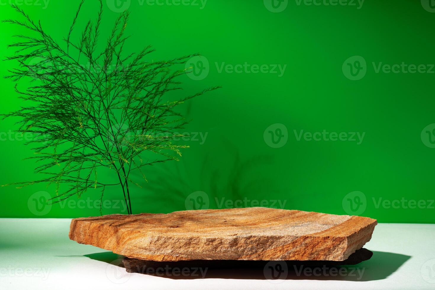 Mock up stone podium against green background photo