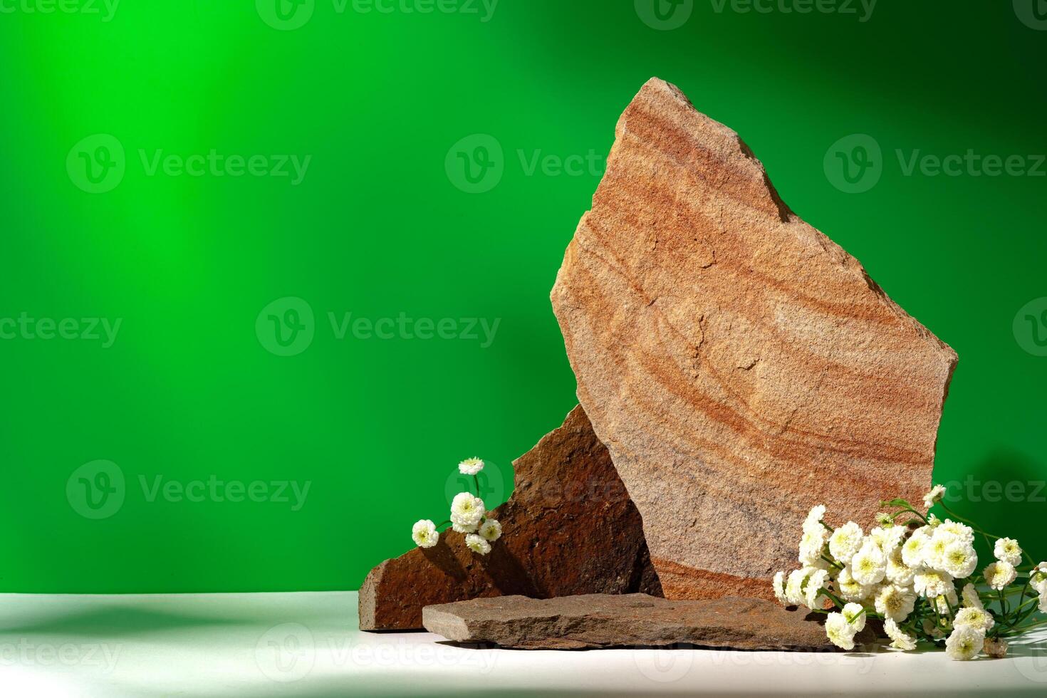 Mock up stone podium against green background photo