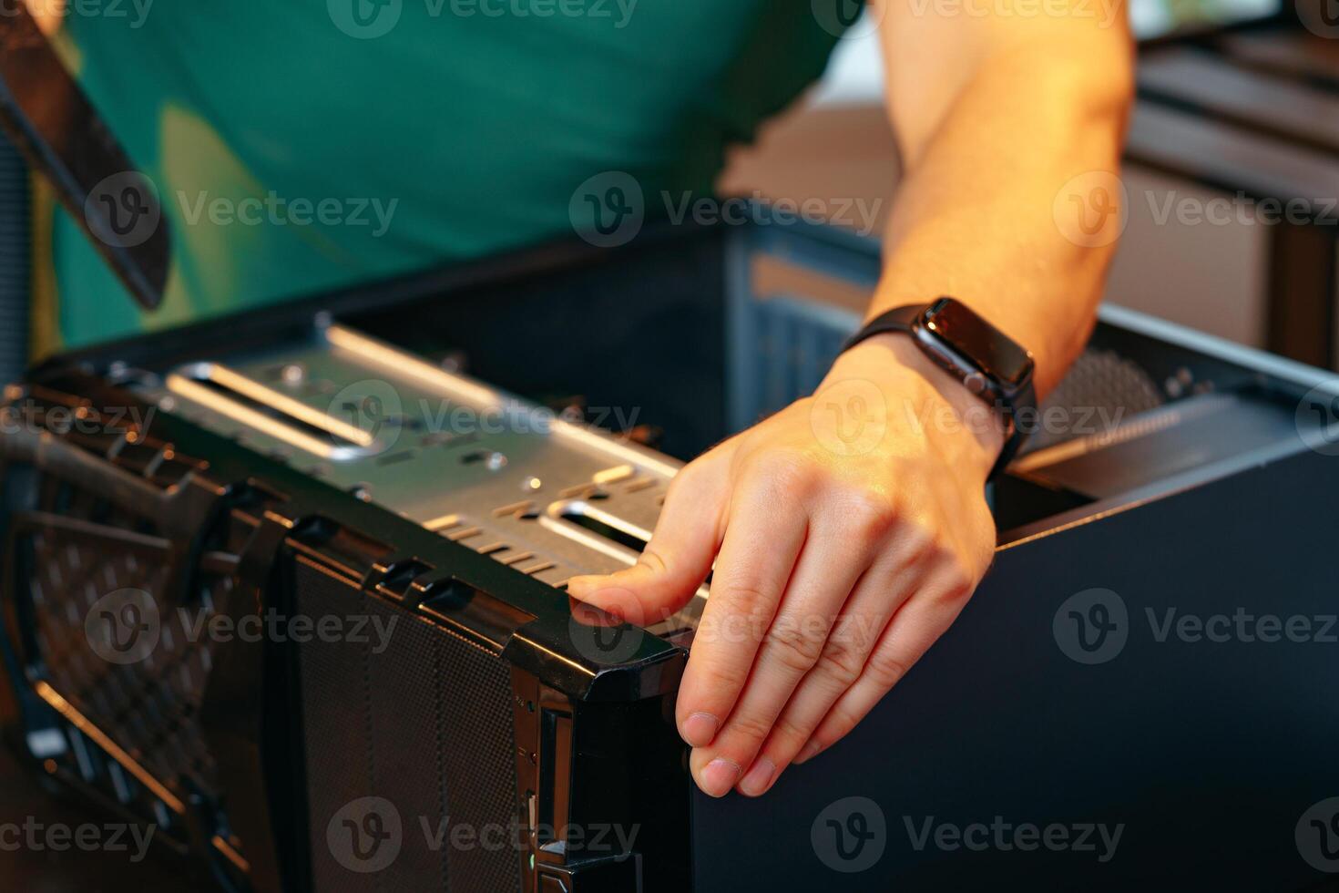 Male hands repairing computer hardware close up photo